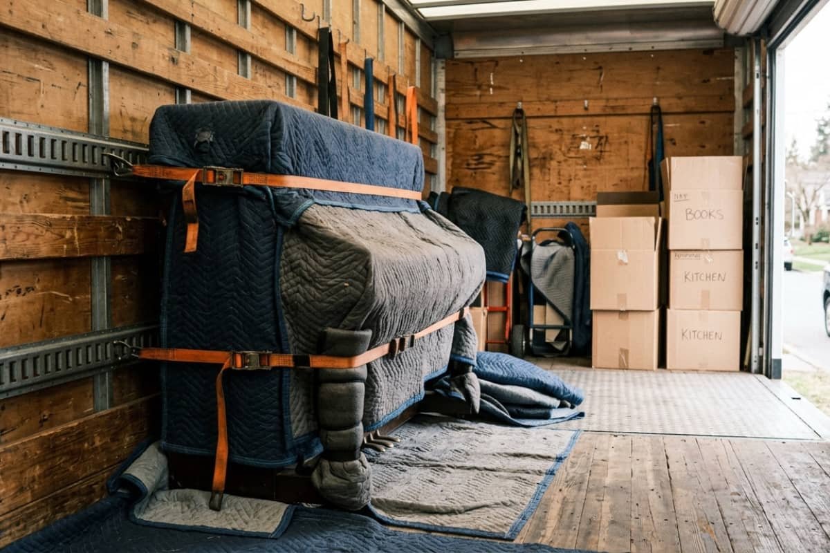 Wrapped piano secured inside a moving truck during a move in London Ontario